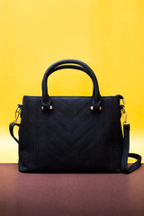 ladies hand bag isolated on yellow background