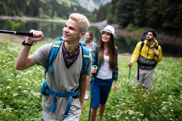Group of happy young people friends hiking together outdoor