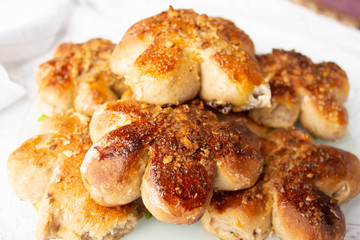 Freshly baked homemade buns with nut topping. Cocoa dough. Tasty, appetizing homemade cakes on a white background