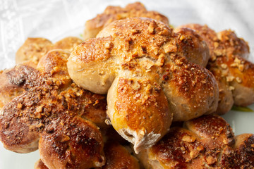 Freshly baked homemade buns with nut topping. Cocoa dough. Tasty, appetizing homemade cakes on a white background