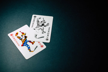 Joker cards on a gray background under the light