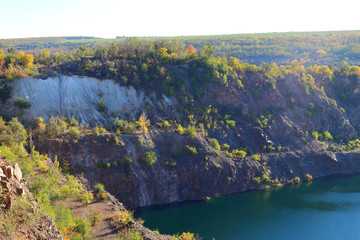 Old abandoned granite quarry full with greenish color water. Radon Lake, located in Ukraine, Migeia. Former granite quarry