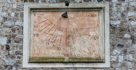 Ancient Antique Sun Dial on a Medieval Tower in Italy