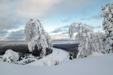 View from a high mountain on a frozen river and endless forests
