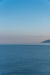 Naklejka na ściany i meble Tiny Fishing Boat on the Southern Italian Mediterranean Sea at Sunrise