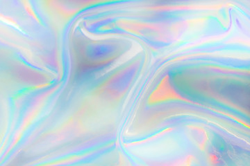 Abstract trendy holographic background. Real texture in pale violet, pink and mint colors with scratches and irregularities