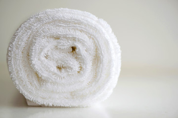 Clean white bath towel.  White delicate soft background of plush smooth fabric. Clean white terry...