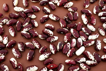 Soybean beans close-up on brown background.