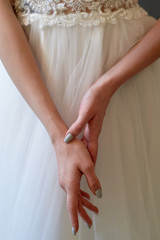 Graceful hands of the bride with slender fingers and brushes. Nervous before the ceremony