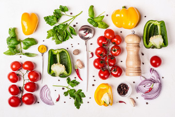 Variety of fresh vegetables, spice mill and spoon with olive oil. Food background and cooking concept