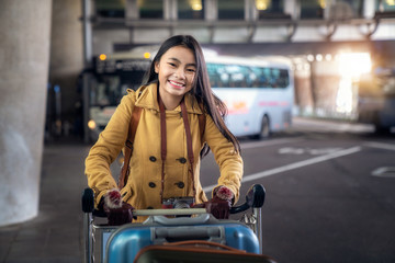 Asian lady carry travel bag in international airport