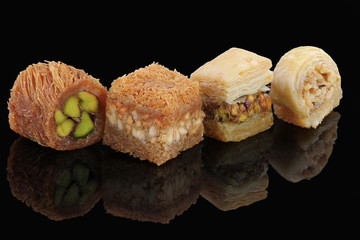 Middle eastern, Turkish sweet pastry baklava isolated on black background