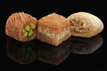 Middle eastern, Turkish sweet pastry baklava isolated on black background
