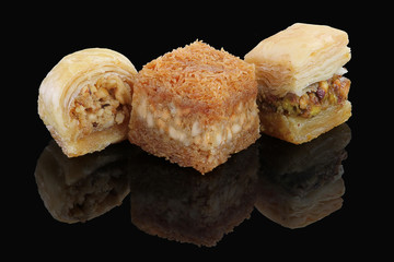 Middle eastern, Turkish sweet pastry baklava isolated on black background