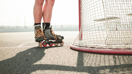  The player in the inline skates stands at his gate. Before the big tournament. Empty ice hockey...