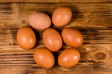 Pile of the hen eggs on wooden table. Top view