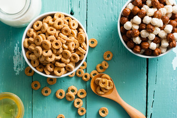 breakfast cereal with milk, honey on blue wood table