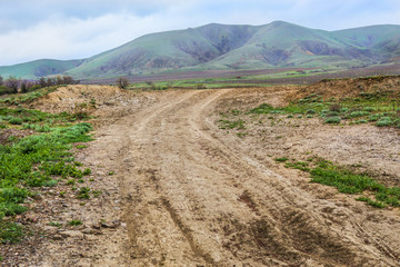 Dirt road to the open mountain range