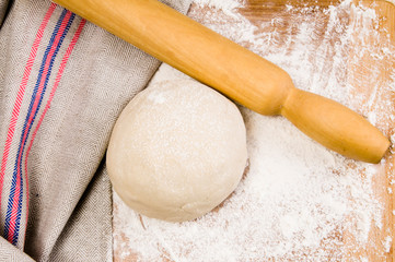 fresh raw dough and rolling pin