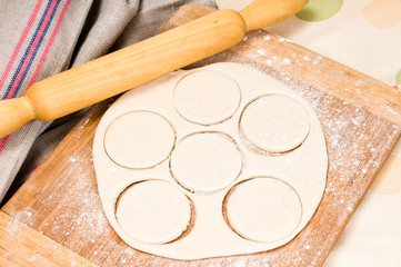fresh raw dough and rolling pin
