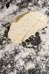 Raw cut dough lies on the table with flour before cooking cottage cheese cookies