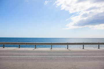 highway with fencing along the sea