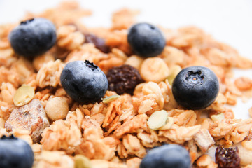 Crunchy muesli and blueberry Breakfast cereals isolated on white background, selective focus, top view