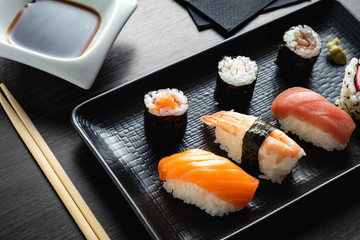 varied sushi plate on wood table