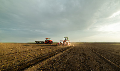  Farmer with tractor seeding soy crops at agricultural field