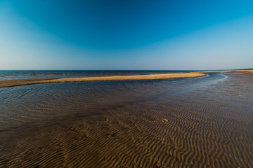 Dessert like textured sand - Baltic sea gulf beach with white sand in the sunset