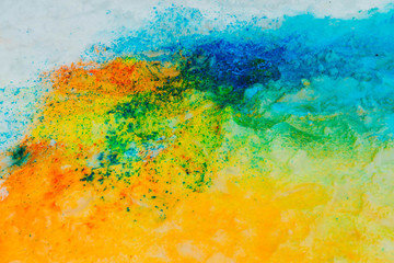 Background of colorful Holi powder on the snow