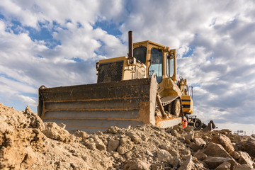 Excavator moving rock and earth in a construction place