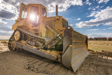 Excavator moving rock and earth in a construction place © Enrique del Barrio