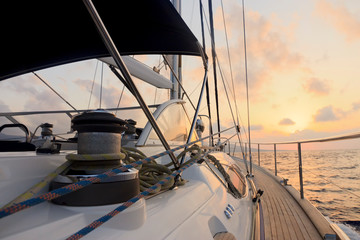 Yacht sailing towards the sunset