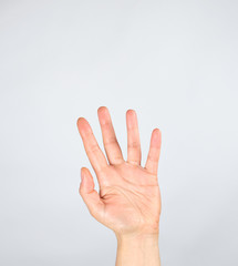 female hand raised up on a white background