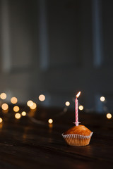  Candles in a cupcake for a holiday. The concept of a festive birthday card. Candles blow out, burning candles with space for text. Beautiful greeting card
