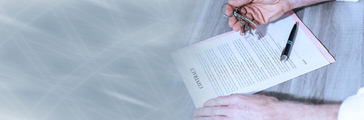 Real estate contract signature (lorem ipsum text used). panoramic banner