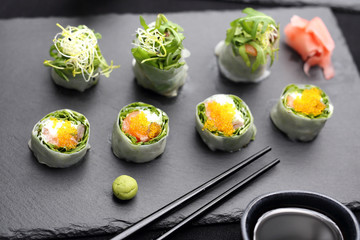 Sushi rolls with salmon, rucola, philadelphia cheese.
