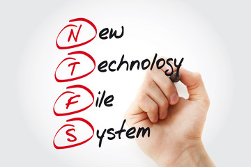 Hand writing NTFS New Technology File System with marker, acronym concept