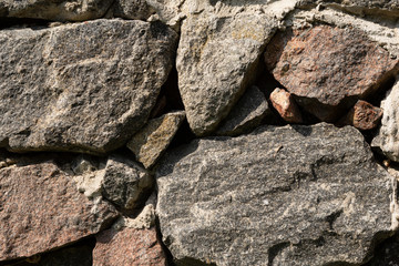 masonry of large natural stones of different sizes, horizontal layout, close-up