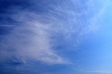 Beautiful white cirrus clouds high in a deep blue sky