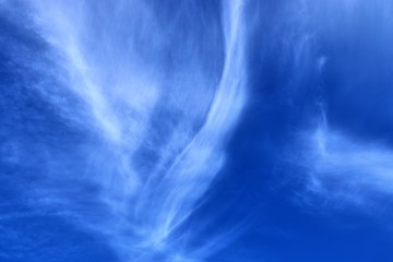 Beautiful white cirrus clouds high in a deep blue sky
