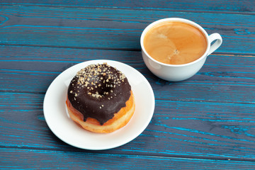 fresh donut with coffee on wooden surface, top view