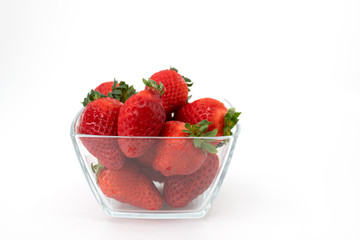 Glass bowl filled with over ripe strawberries