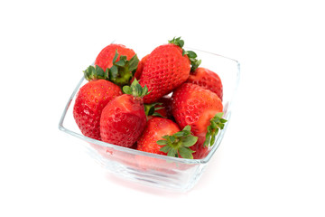 Glass bowl filled with over ripe strawberries