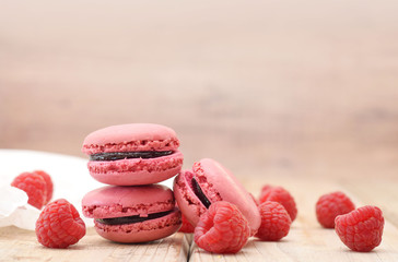 Pink Macarons with raspberry jam and fresh berries closed up