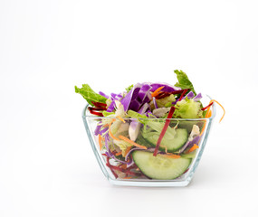 Sweet salad in a glass bowl on a white background