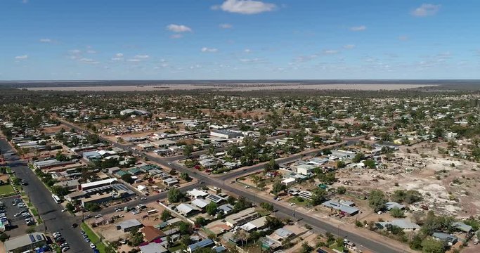 Lightning Ridge remote opal mine town in outback NSW Australia – aerial backward flying over streets and houses of down town.