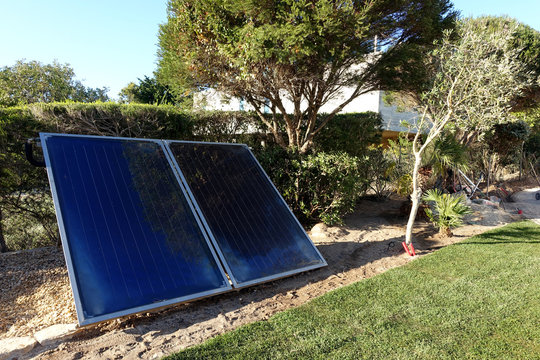 Solar panels in front garden of house