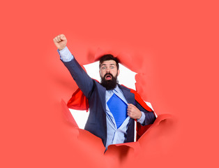 Bearded man looking through paper. Through paper. Super businessmen in red cape showing blue shirt....
